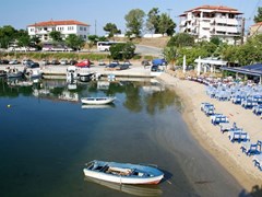 The port of the resort of Neos Marmaras in Chalkidiki, Greece, with a restaurant on the beach